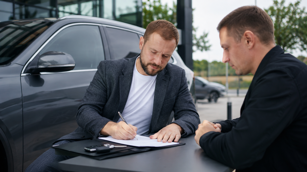 Договір купівлі-продажу авто 2026 – покупець та продавець підписують документи біля автомобіля